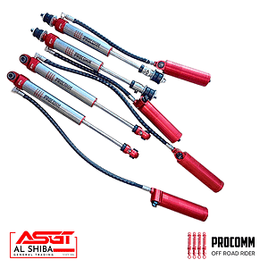 Set of red and silver off-road shock absorbers with braided hoses, branded Procomm, shown diagonally across a white background.