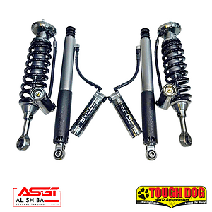 Pair of heavy-duty off-road coilover shock absorbers with springs, laid out side by side, branded by Al Shiba and Tough Dog