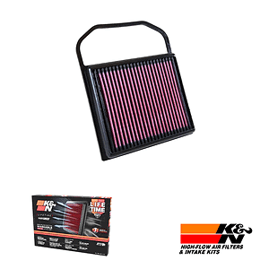 Rectangular air filter with pink pleated media in a black frame, used in automotive intake systems; includes a carrying handle edge visible above the filter.